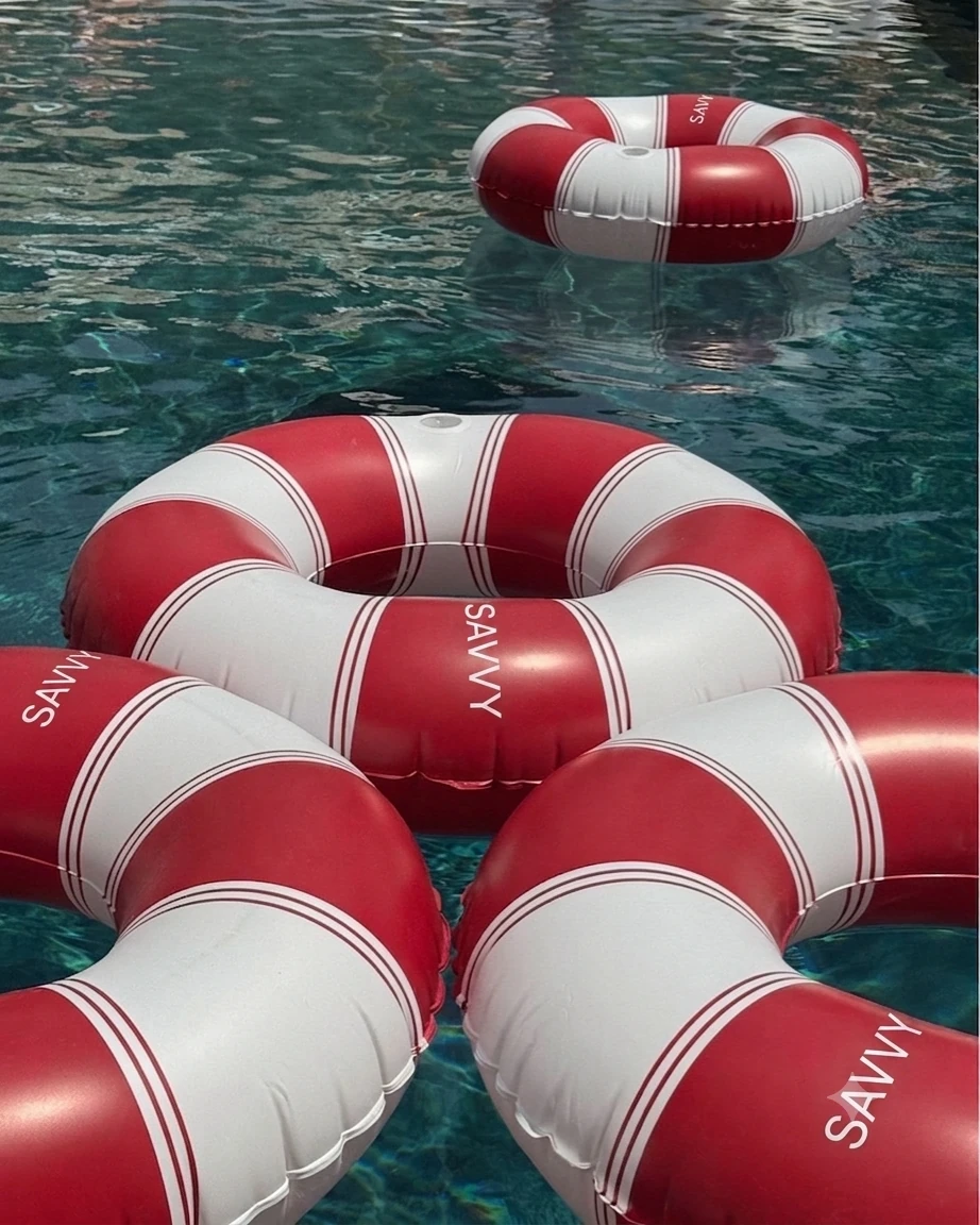 Red and white Savvy Swim ring floats on the water
